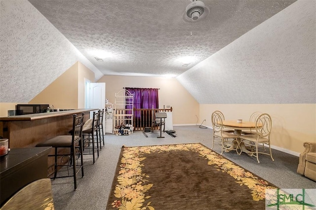 interior space with carpet flooring, a textured ceiling, and lofted ceiling