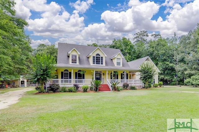 cape cod house featuring a front yard