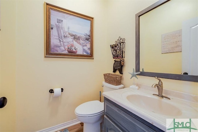 bathroom featuring vanity and toilet