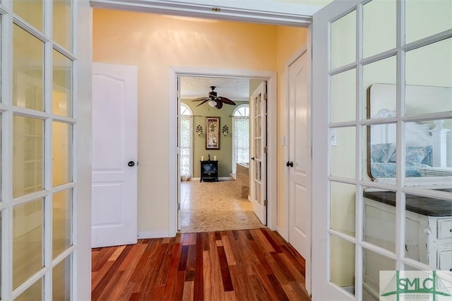 hallway with dark wood-type flooring and french doors