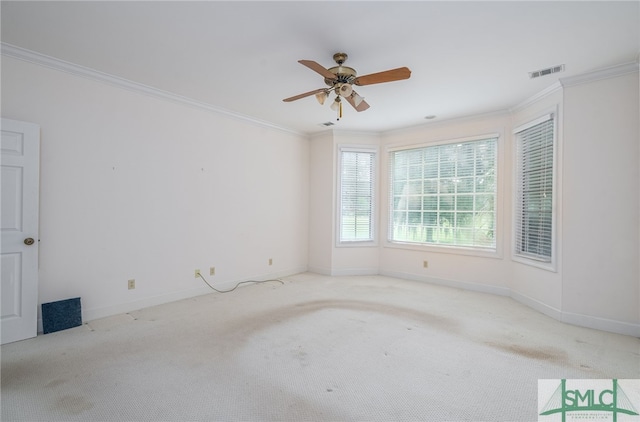 unfurnished room with ceiling fan, crown molding, and light carpet