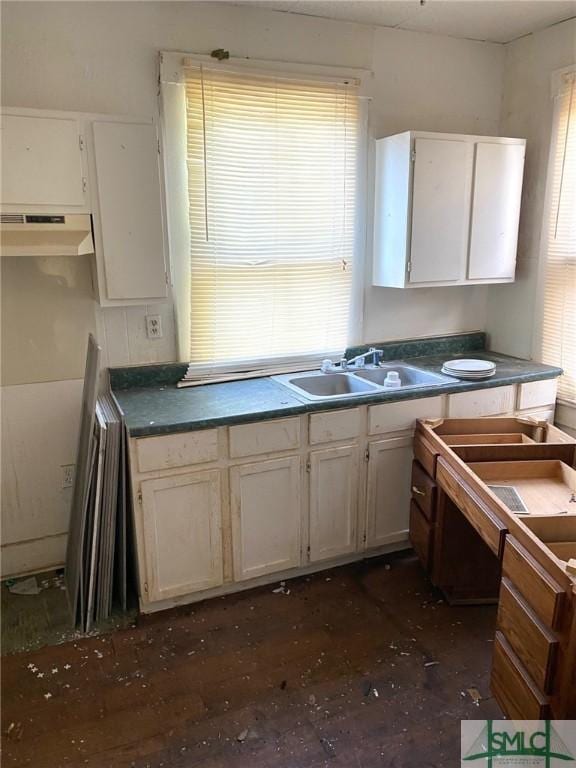 kitchen with white cabinetry, sink, and a healthy amount of sunlight