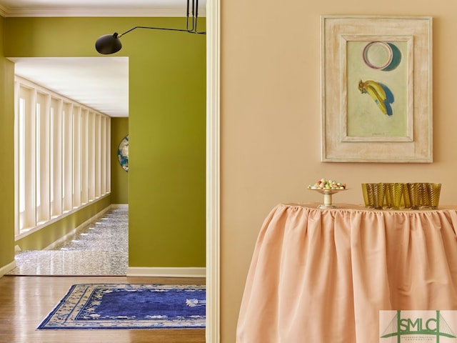 interior space featuring crown molding and hardwood / wood-style floors