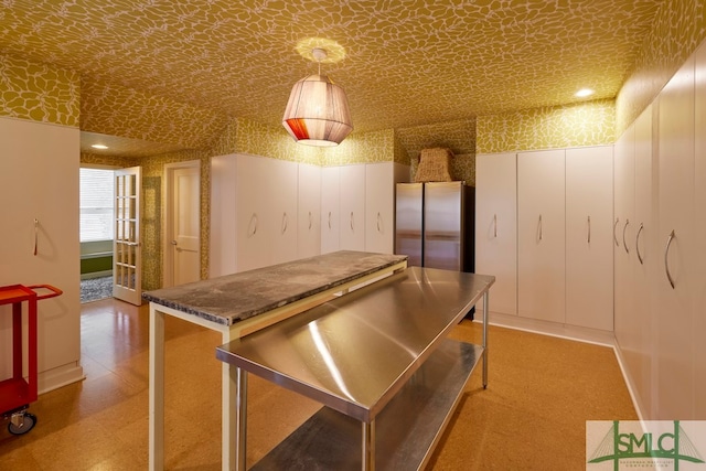 kitchen featuring hanging light fixtures and stainless steel fridge