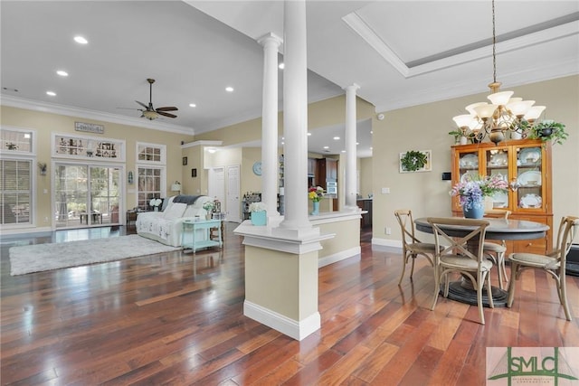 kitchen featuring decorative columns, dark wood-type flooring, ceiling fan with notable chandelier, and decorative light fixtures