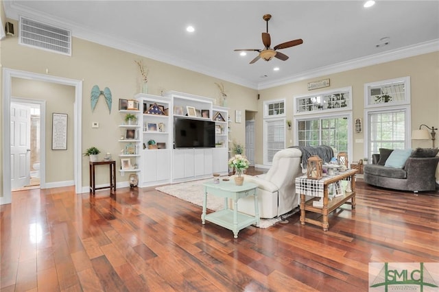 living room featuring crown molding, dark wood-type flooring, and ceiling fan