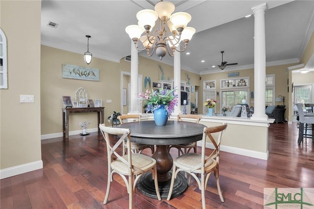 dining space with ornate columns, ornamental molding, dark hardwood / wood-style floors, and ceiling fan with notable chandelier