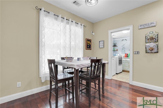 dining room featuring washer / dryer and hardwood / wood-style floors