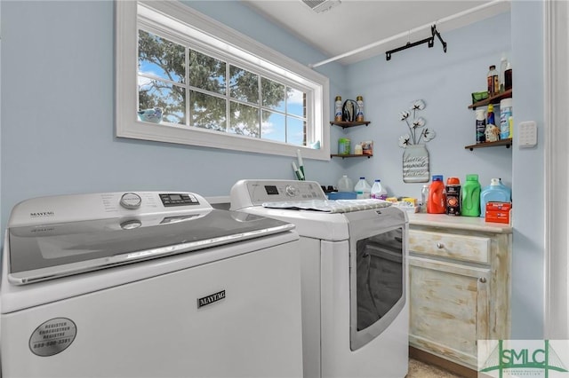 clothes washing area featuring washing machine and clothes dryer