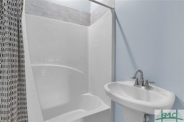 bathroom featuring sink and shower / bath combination with curtain