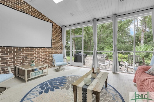 sunroom featuring vaulted ceiling