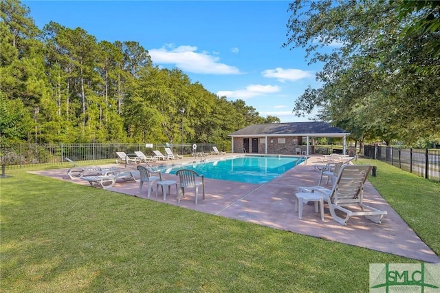 view of swimming pool featuring a yard and a patio area