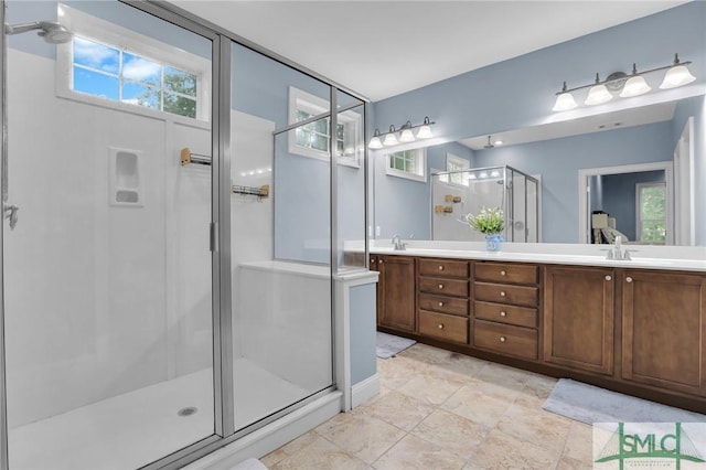 bathroom with vanity and a shower with door