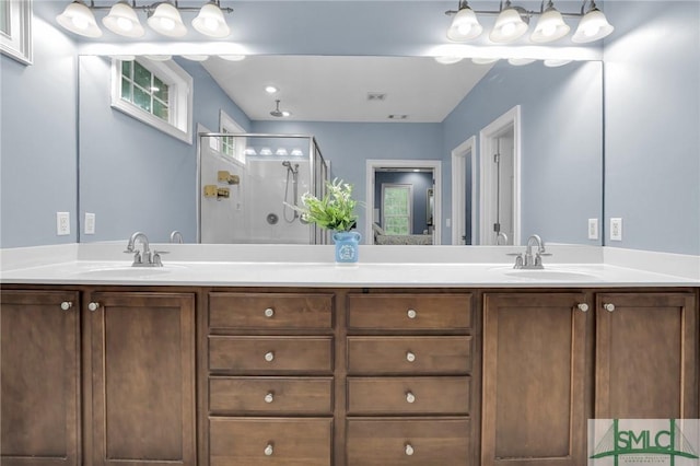 bathroom featuring vanity and a shower with shower door