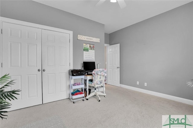 home office with ceiling fan and light carpet