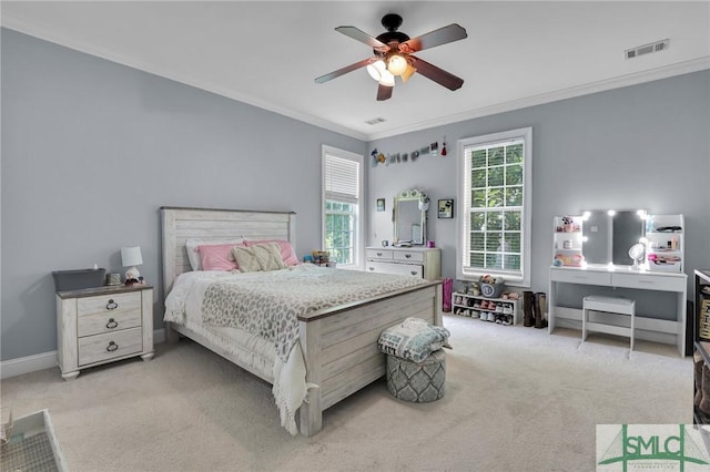 carpeted bedroom featuring crown molding and ceiling fan