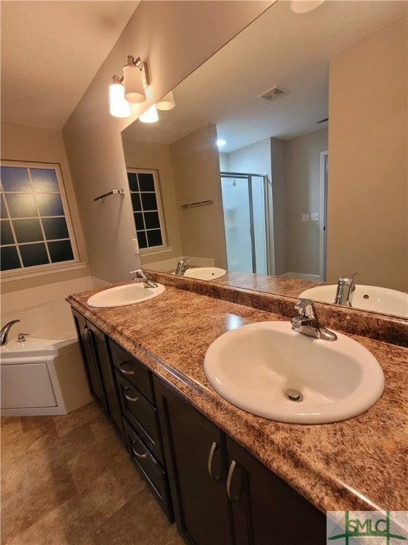 bathroom with plus walk in shower, tile patterned flooring, and dual bowl vanity