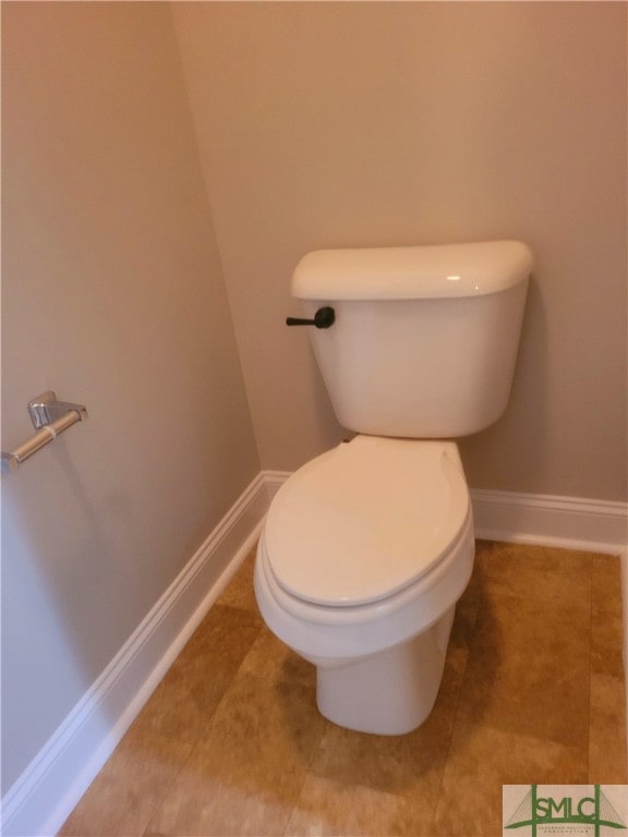 bathroom with tile patterned flooring and toilet