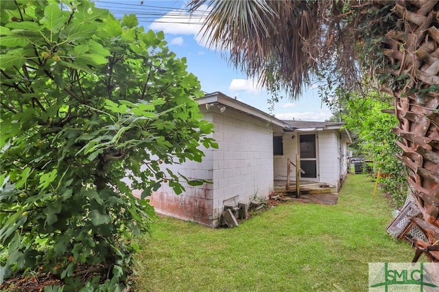 view of side of home with a lawn