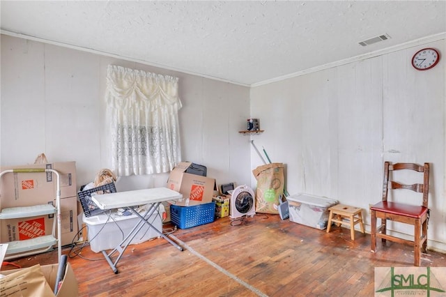 miscellaneous room featuring hardwood / wood-style floors and a textured ceiling