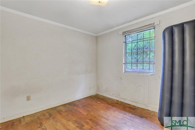 empty room featuring hardwood / wood-style floors and ornamental molding