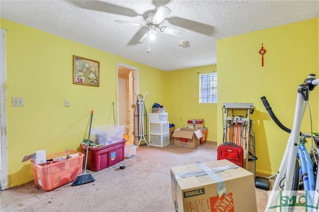 playroom featuring a textured ceiling, light colored carpet, and ceiling fan