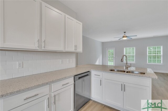 kitchen featuring dishwasher, kitchen peninsula, light hardwood / wood-style floors, and sink