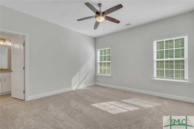 unfurnished room featuring light colored carpet and ceiling fan