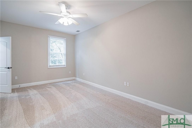 unfurnished room with light colored carpet and ceiling fan