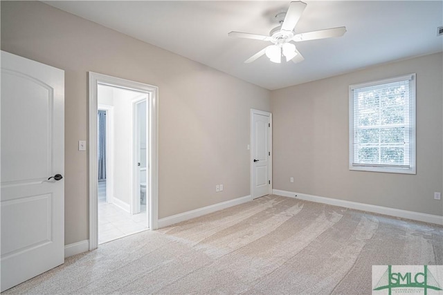 empty room with ceiling fan and light carpet