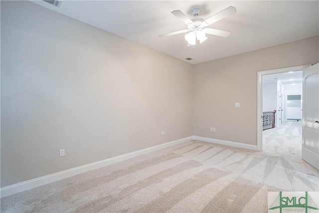 carpeted spare room with ceiling fan