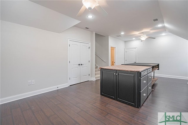 kitchen featuring dark hardwood / wood-style flooring, ceiling fan, and a center island