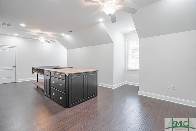 kitchen featuring ceiling fan, a center island, dark hardwood / wood-style flooring, and lofted ceiling