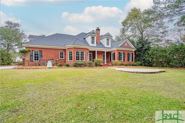 cape cod home with a front lawn