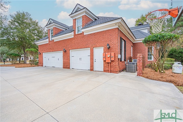 view of property exterior with a garage and central air condition unit