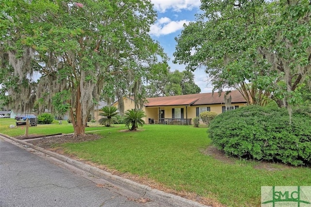 single story home featuring a porch and a front yard