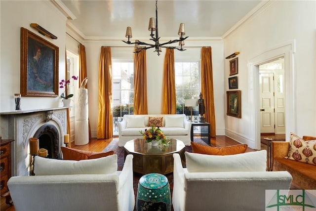 living area featuring ornamental molding, wood-type flooring, and a notable chandelier