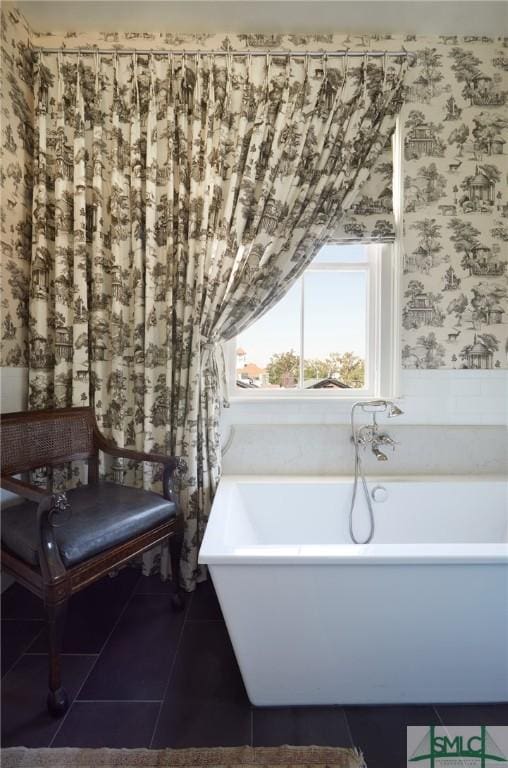 bathroom featuring tile patterned floors and a washtub