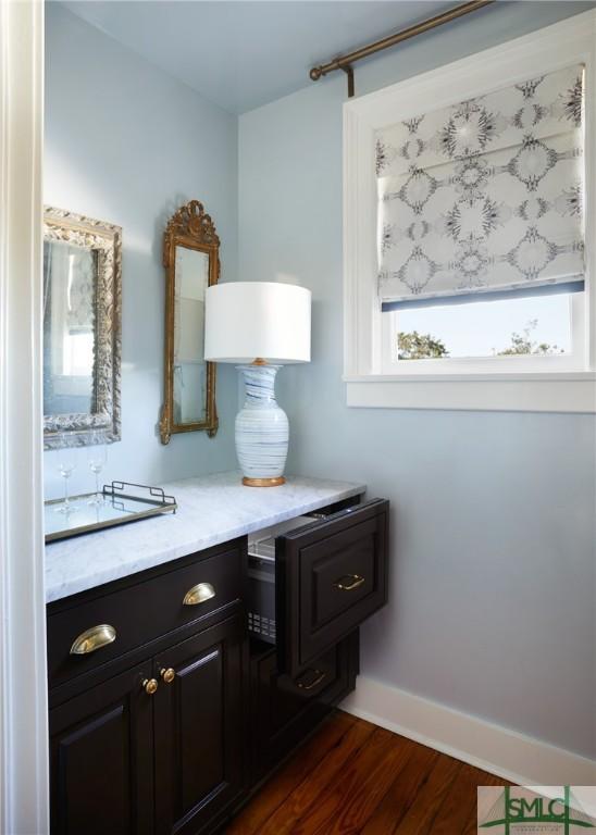 bathroom with hardwood / wood-style floors, vanity, and a healthy amount of sunlight