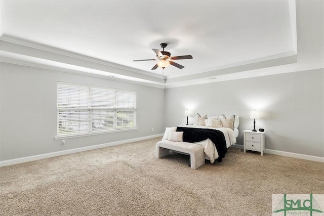 carpeted bedroom featuring ceiling fan, crown molding, and a raised ceiling