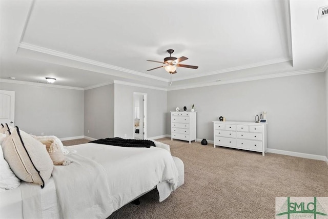 bedroom with light carpet, ceiling fan, crown molding, and a tray ceiling