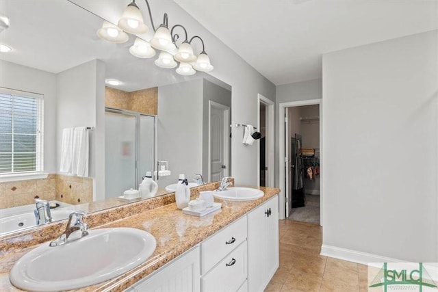 bathroom featuring vanity, tile patterned flooring, an enclosed shower, and a notable chandelier