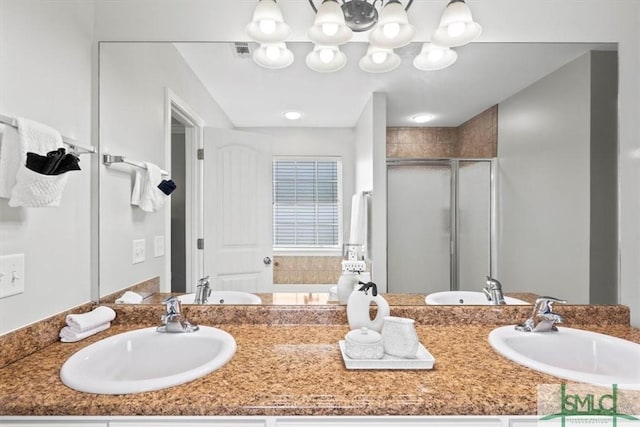 bathroom with a shower with shower door and vanity