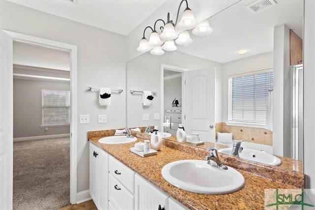 bathroom featuring tile patterned flooring, a shower with door, and vanity