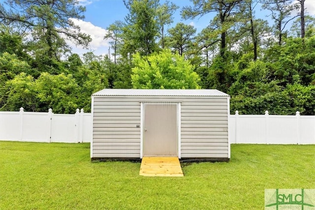 view of outbuilding featuring a lawn