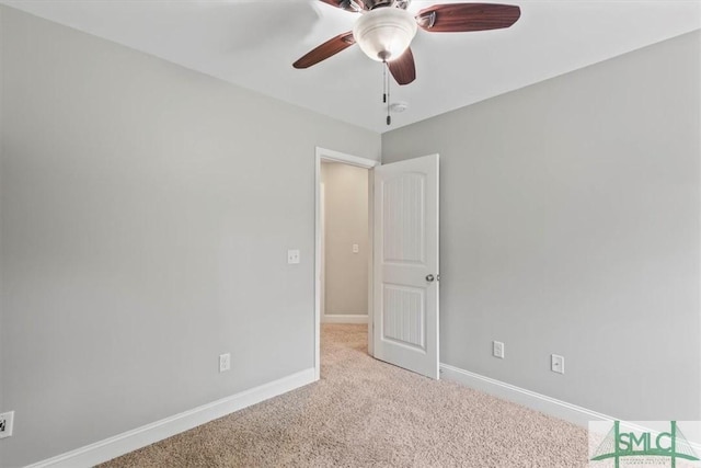 spare room featuring ceiling fan and light colored carpet