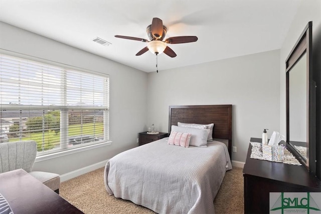 bedroom featuring ceiling fan and carpet