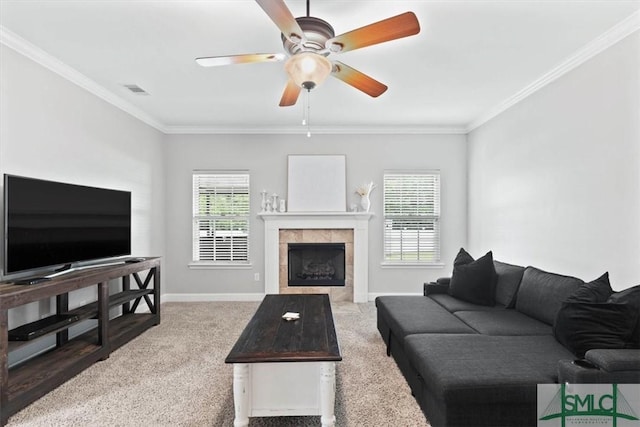 living room with a healthy amount of sunlight, crown molding, and carpet flooring