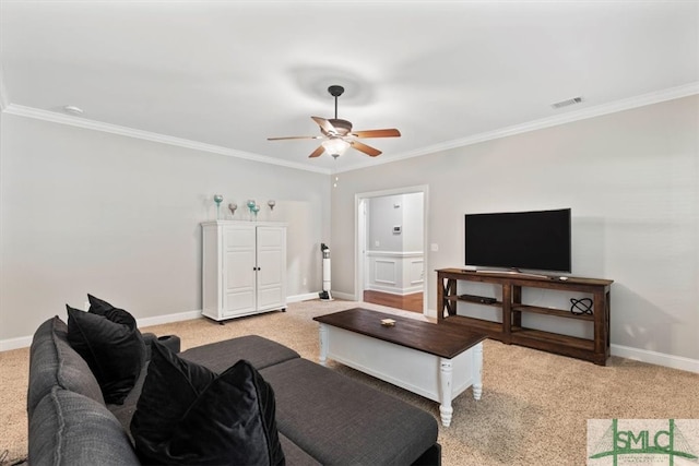 carpeted living room featuring ceiling fan and ornamental molding