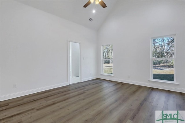 spare room featuring ceiling fan, high vaulted ceiling, and wood-type flooring